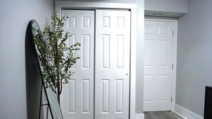 A bedroom with a bed, a white door, and a plant. - Modern Minimalist Home in the heart of Reading (Reading)
