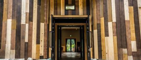 A hallway with a wooden wall and a stone base.