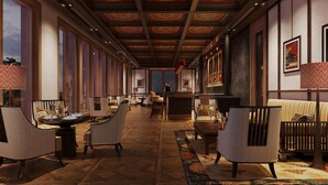 Eine großzügige Hotelhalle mit einer langen Rezeption, mehreren Sitzbereichen und einem gemusterten Teppich.