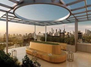 A modern rooftop lounge with a circular glass ceiling, offering panoramic city views. - Stylish Edge Apartment Walk to Albert Park & Beach (Melbourne)