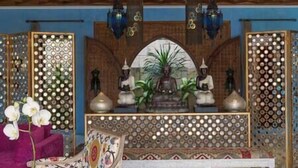 A reception area with a decorative counter, hanging lamps, and a patterned backdrop. - Sayang d'Amour by Elite Havens (Seminyak)
