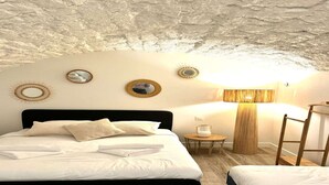 A bedroom with a black bed, white bedding, a round mirror, and a lamp on a small table. - Apartment Saint Germain des Pres Bon Marche (Paris)