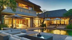 A modern house with a pool, outdoor seating, and a well-lit patio area. - Kaba Kaba Estate by Elite Havens (Tabanan)