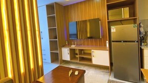 A modern kitchen with a built-in microwave, a refrigerator, and a wooden cabinet. - Smile's Home (Nairobi)