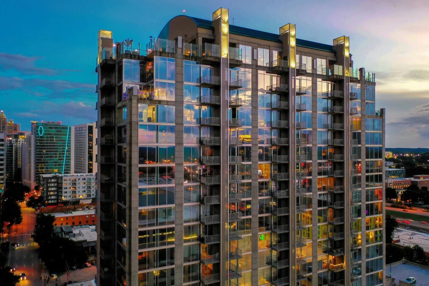 A high-rise building with multiple balconies and large windows, likely a hotel or office building.