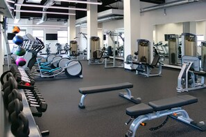 A gym with various exercise equipment, including dumbbells, benches, and weight machines. - Terminal Tower - Spacious! RnRHoF, Casino, Stadium (Cleveland)