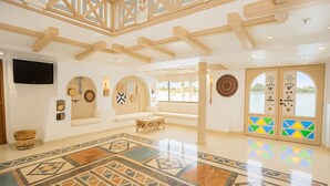 A spacious lobby with a high ceiling, a large seating area, a patterned floor, and a view of the outdoors. - Nile Cruise Majesty every Monday from Aswan 3 nights and every Thursday from Luxor 4 nights (Aswan)