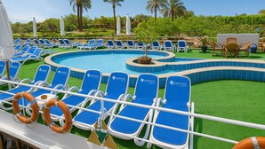 A pool area with blue lounge chairs and a small hot tub. - Nile Cruise Majesty every Monday from Aswan 3 nights and every Thursday from Luxor 4 nights (Aswan)