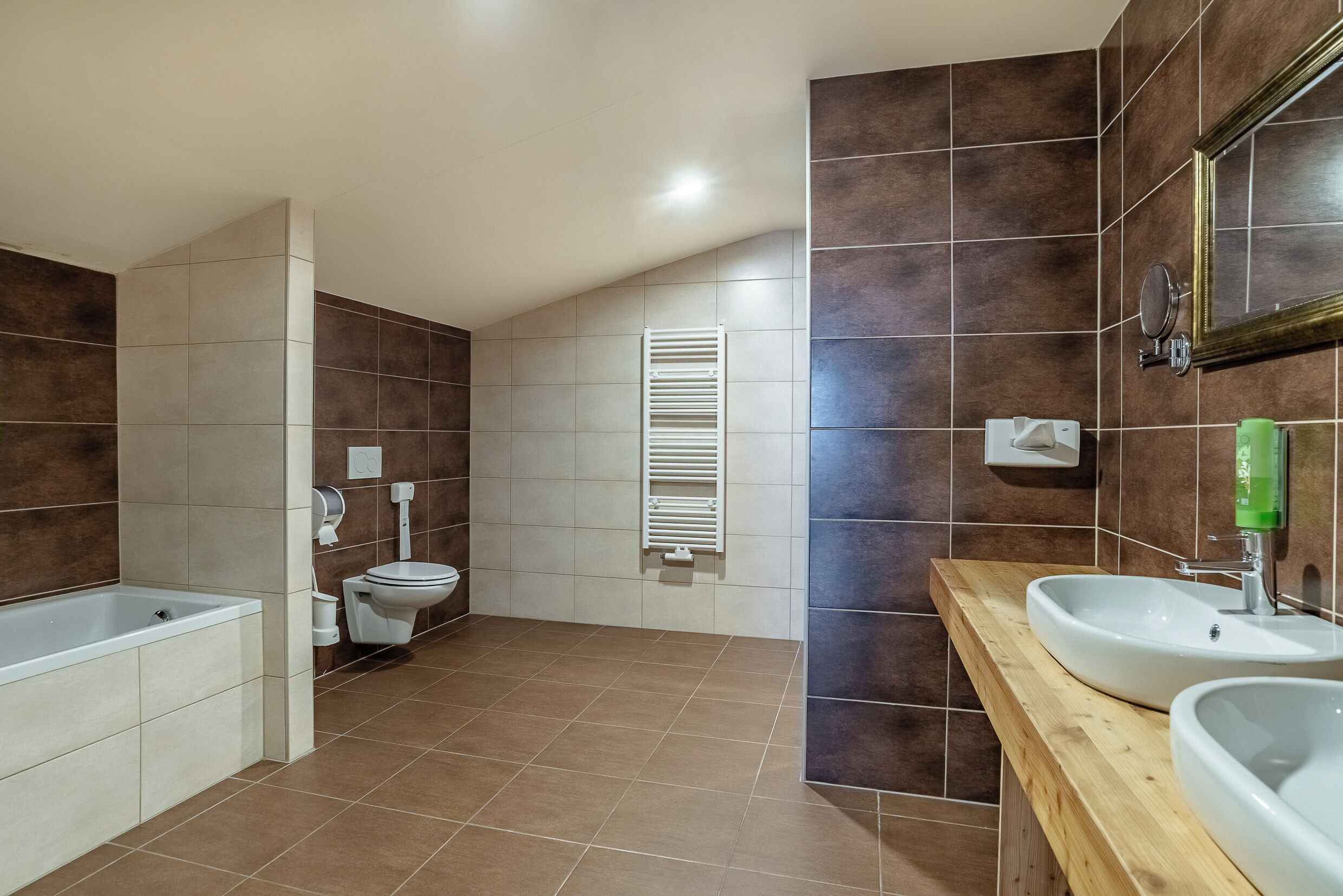 A modern bathroom with a bathtub, toilet, and sink.