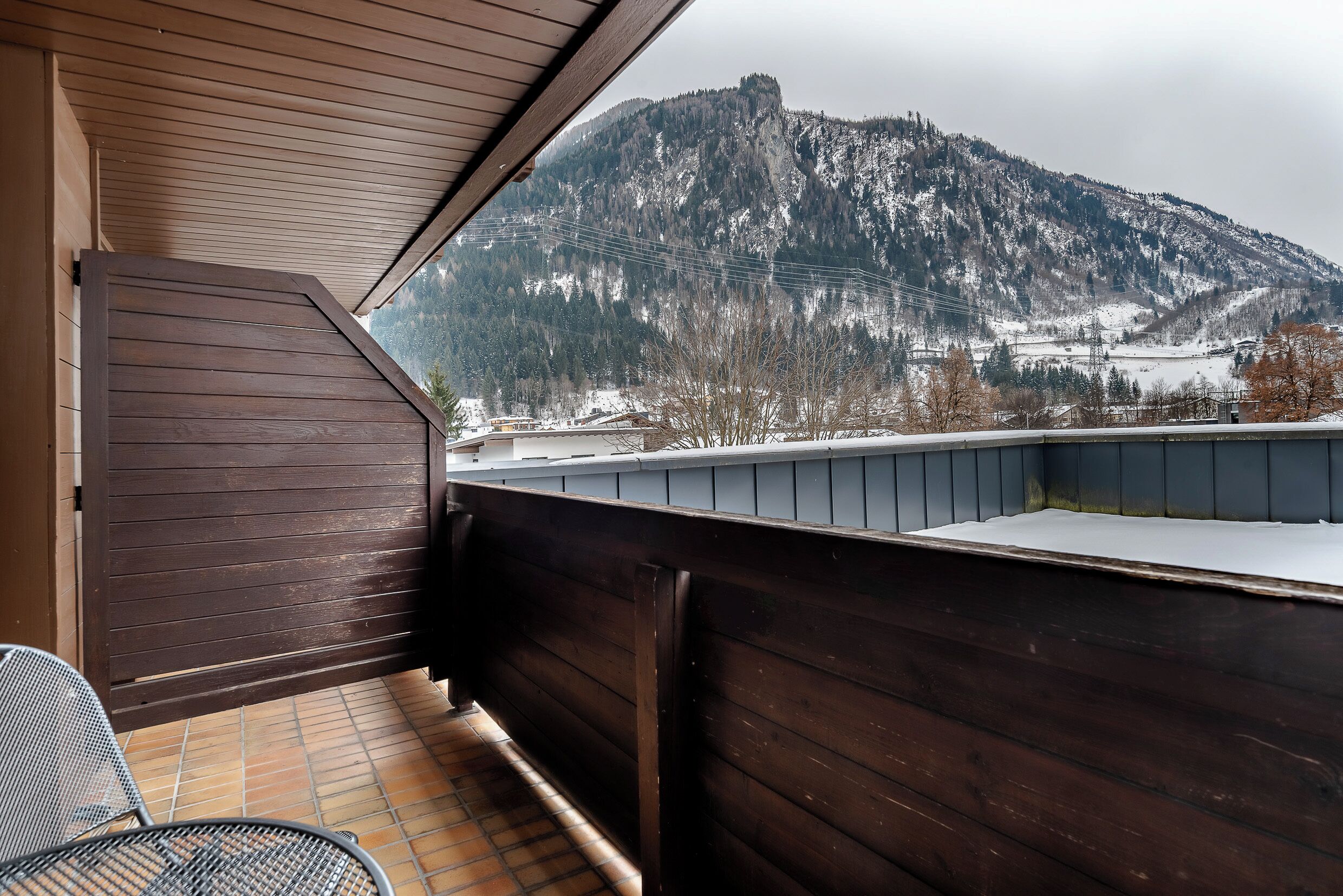 A balcony with a view of a snow-covered mountain.