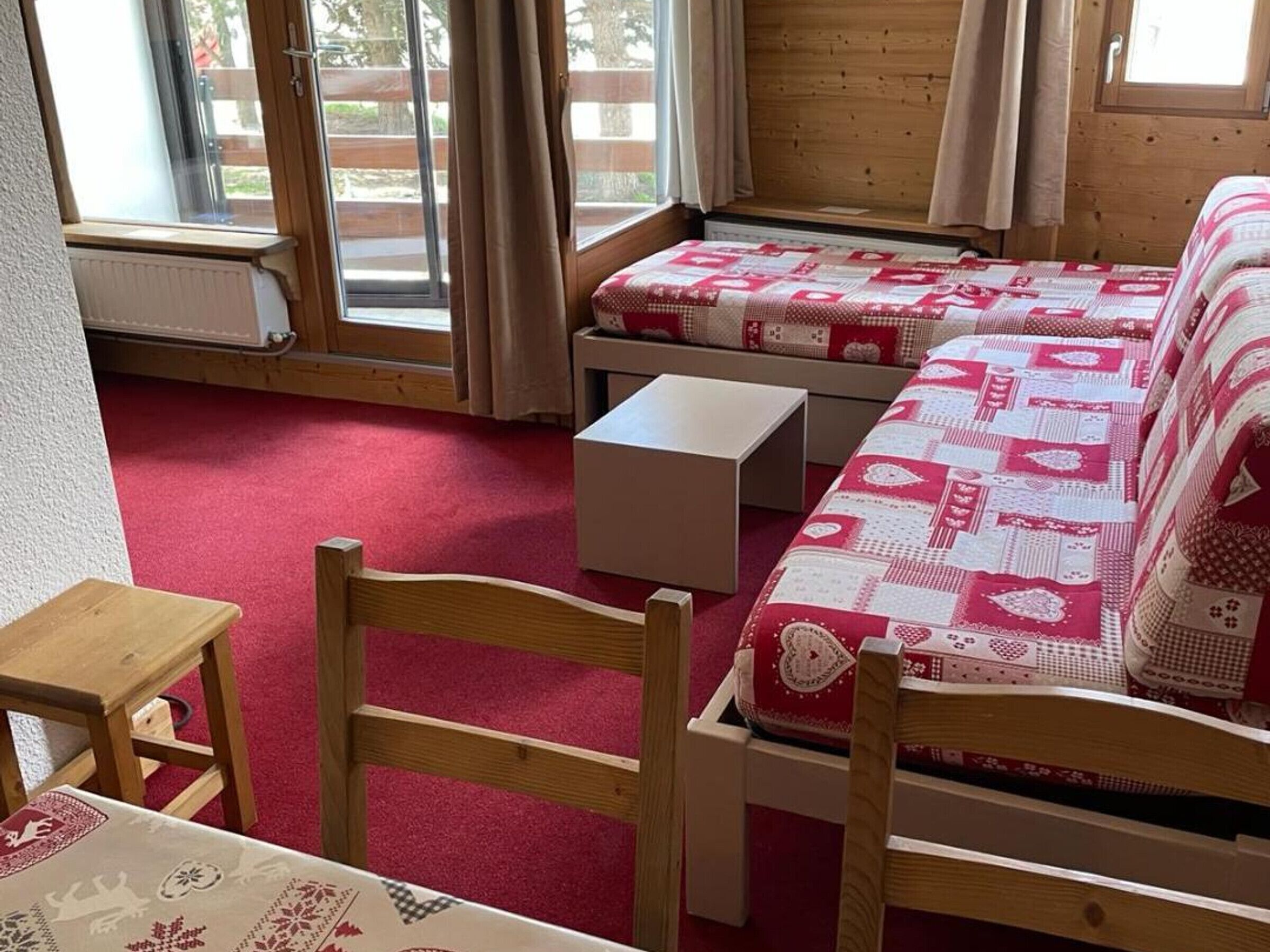 Una habitación acogedora con cama, una mesita y una silla.