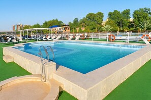 Outdoor pool, pool umbrellas, sun loungers