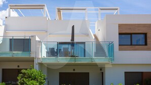 A modern multi-story building with a glass balcony, a staircase, and a chimney. - Casa de Lipa in Orihuela Costa (Orihuela)
