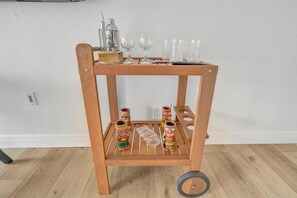 A wooden shelf with glasses, a cocktail shaker, and tiki mugs. - 2 Beds Waterfront Condo & Balcony | Heated Pool! (Tampa)