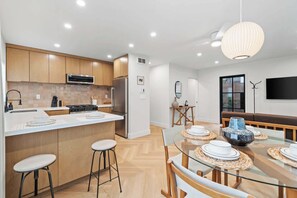 
Modern, fully-equipped kitchen and dining area perfect for creating and sharing meals. Enjoy the open layout and the comfortable, welcoming atmosphere. - La Jolla Luxury 2BR | Tesla Charger + Parking (San Diego)