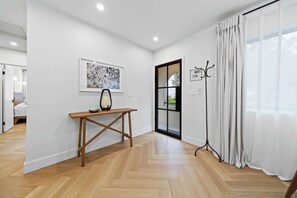 
Welcome home! This bright, inviting entryway features a stylish console table and coat rack, leading into the rest of the beautifully designed space. - La Jolla Luxury 2BR | Tesla Charger + Parking (San Diego)