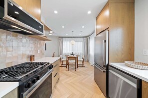 Whip up your favorite dishes in this full-size, modern kitchen with stainless steel appliances, then enjoy them at the dining table just steps away.