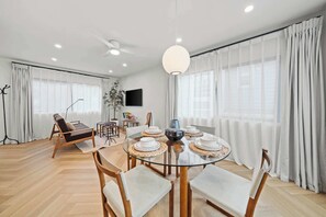 An open-concept living and dining area with a modern feel. The space is filled with natural light, making it a perfect spot to relax after a day of exploring.