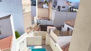 A rooftop pool with a view of surrounding buildings. - Pepa · Serenity Apartment (Nerja)