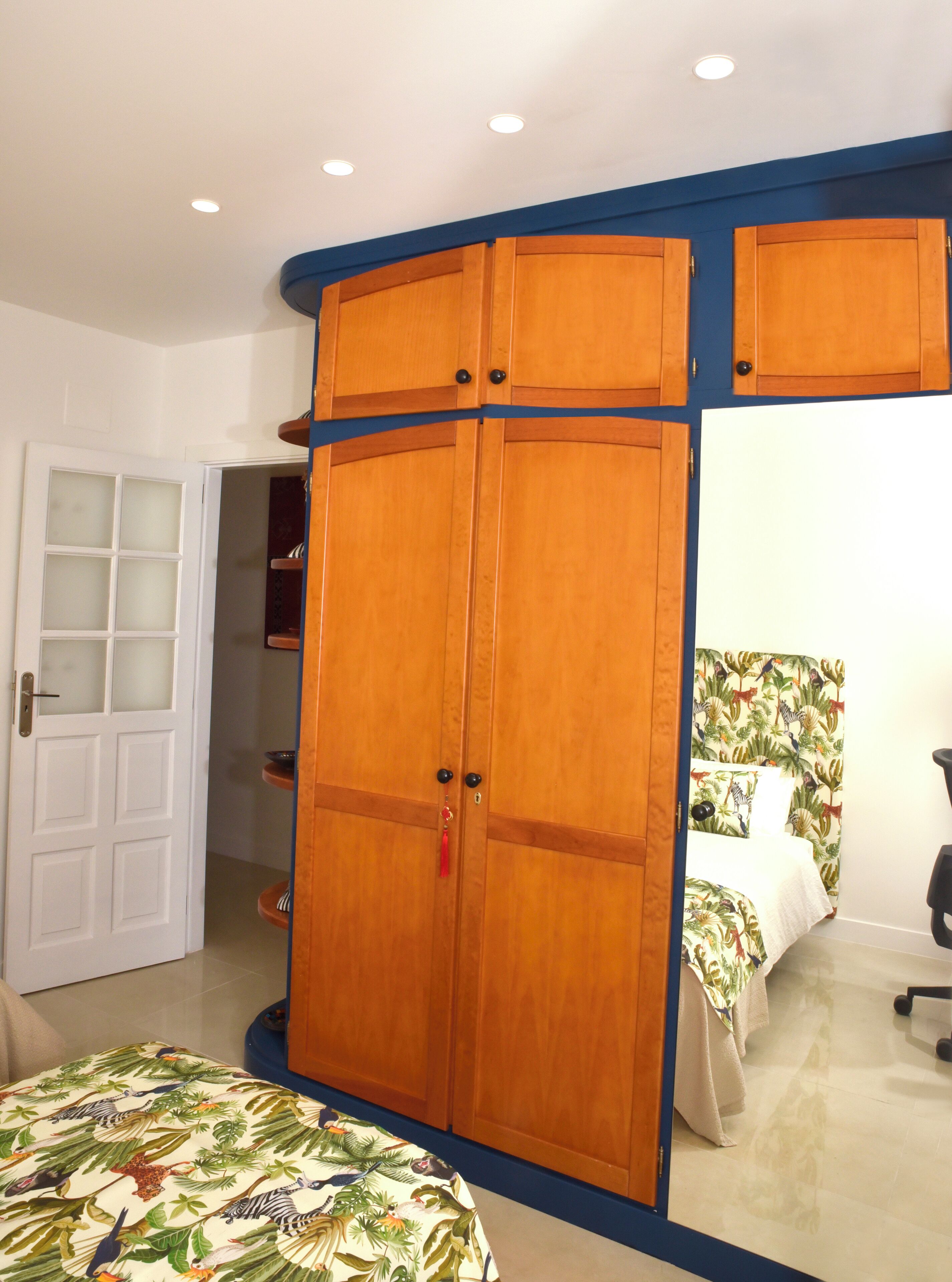 Ein Schlafzimmer mit einem Bett, einem Kleiderschrank und einer Tür zu einem Badezimmer.