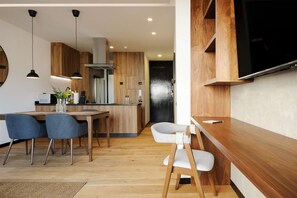 A modern kitchen with wooden cabinets, a central island, and pendant lighting. - w Fabulous 1BR With Elegant Balcony in Roma Nte (Mexico City)