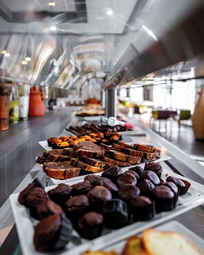 A buffet with various desserts including brownies and cupcakes.