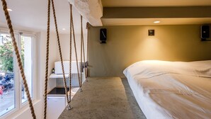A bedroom with a bed, a small desk, a chair, and a window. - (034) Le Cocon Méditerranéen (Antibes)
