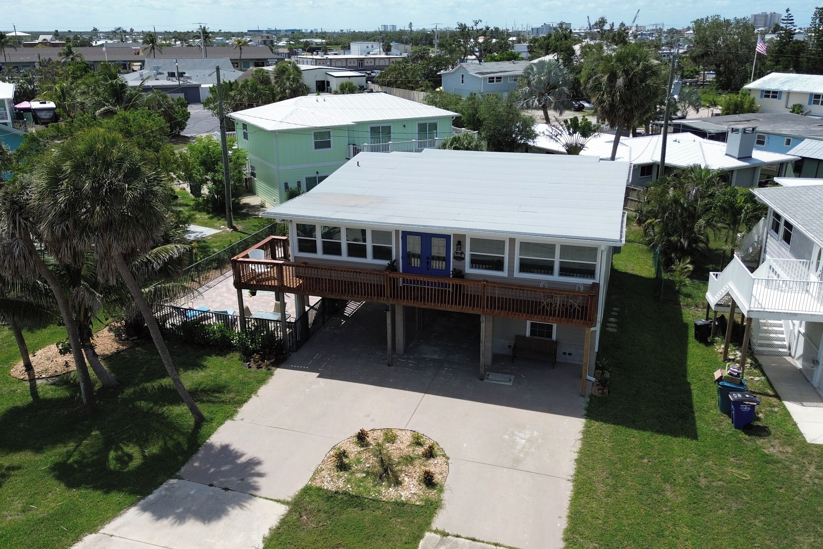 A two-story house with a covered porch, a small front yard, and a clear view of the neighborhood.