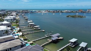 A marina with docked boats, a small island, and a coastal town with buildings and a clear sky. - 1 Mi to Fort Myers Beach Access! Chic Coastal Home (Fort Myers Beach)