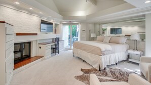 A bedroom with a bed, desk, chair, TV, and a view of the outdoors. - 1 Mi to OU! Group Getaway w/ Game Room, Pool (Norman)