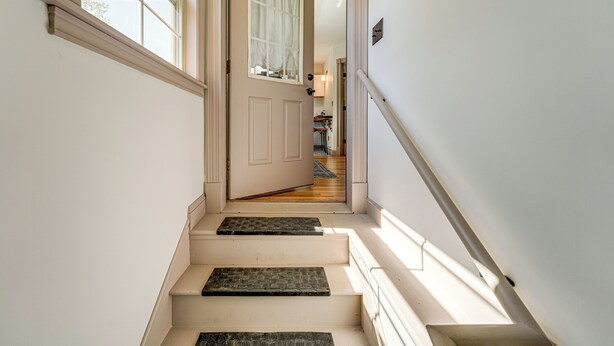 A staircase with a door at the top leading to a room. - Charming Apt w/ Shared Outdoor Space in Lisbon! (Lisbon)
