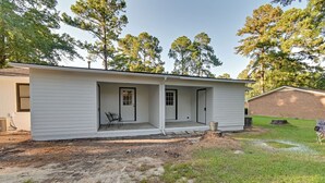 A single-story house with a covered porch, a small patio area, and a brick garage. - Private Patio: Apt 6 Mi to Cheraw State Park! (Cheraw)