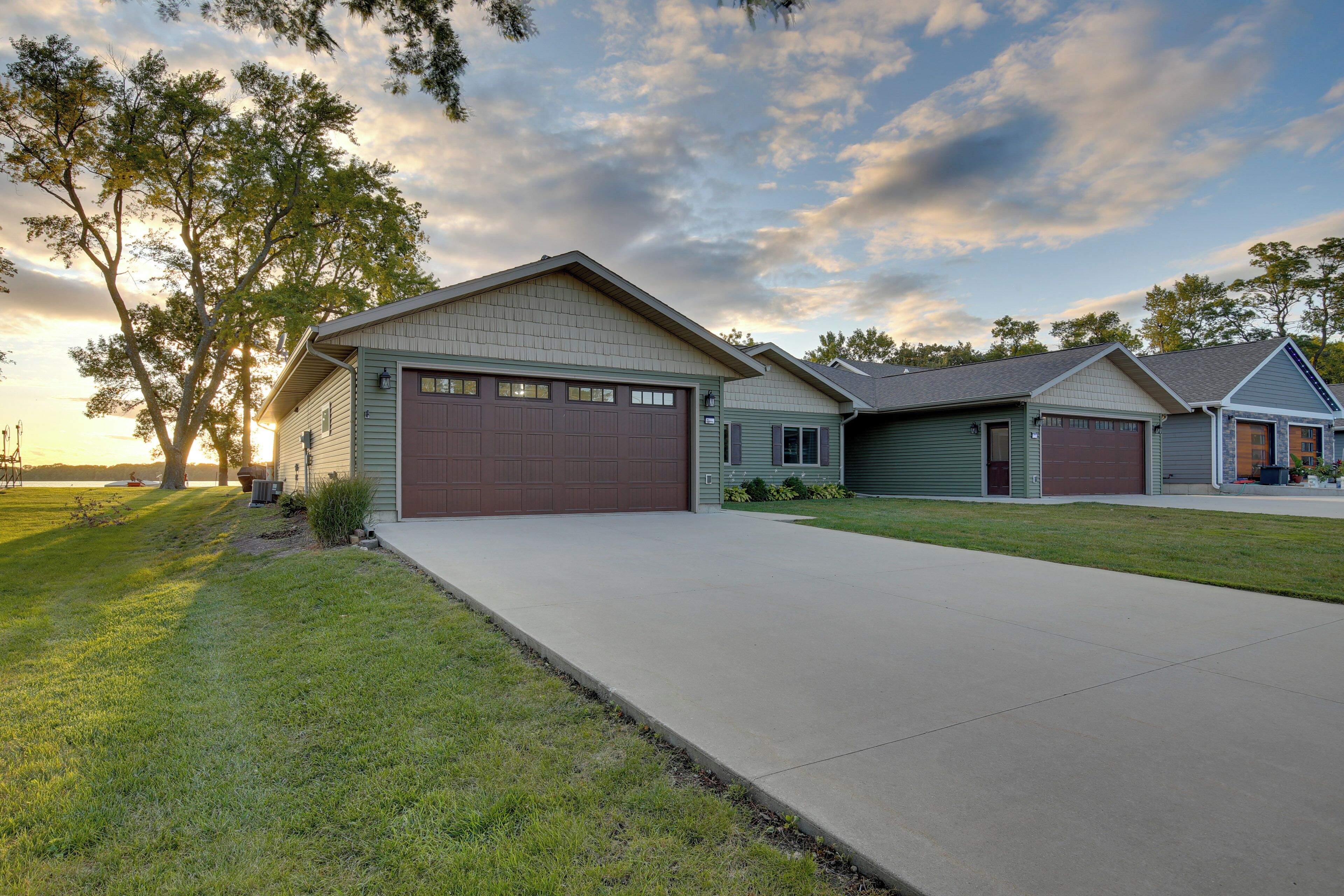 A residential area with houses, a driveway, and a grassy lawn.
