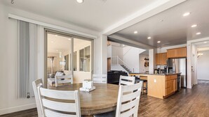 A modern kitchen with wooden cabinets and a stainless steel refrigerator. - 1 Mi to Golf! Spacious & Modern Home in Dinuba (Dinuba)