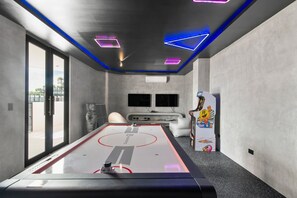 A room with a pool table, a foosball table, and a large window. - Perfect Jungle Retreat Near Beaches & Hotel Zone (Tulum)