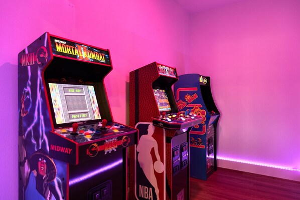 Arcade machines with "Midway" branding and "Mortal Kombat" graphics.