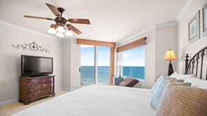 A bedroom with a large bed, a ceiling fan, a TV, and a view of the ocean. - NEW LISTING!!! Seaspray East 922 - Beach Front - HASSLE-FREE CHECK OUT (Perdido Key)