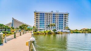 A waterfront hotel with a wooden boardwalk leading to a building with multiple balconies. - NEW LISTING!!! Seaspray East 922 - Beach Front - HASSLE-FREE CHECK OUT (Perdido Key)