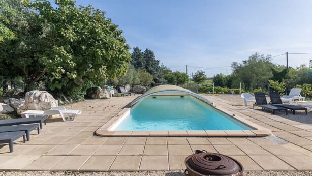 A rectangular swimming pool with a curved edge, surrounded by a tiled deck. - Holiday Home 'Gîte 1 - La Tour' with Lake View and Wi-Fi (Saint-Sauveur de Cruzières)