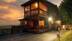 A two-story log cabin with a balcony, a grill, and a sign indicating it's a campground. - God's View - Pet Friendly, Blue Ridge GA (Blue Ridge)