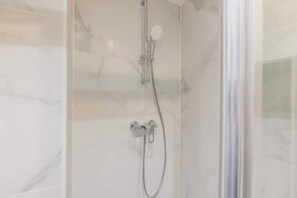 Shower, hair dryer, towels, toilet paper