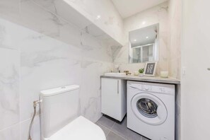 Shower, hair dryer, towels, toilet paper