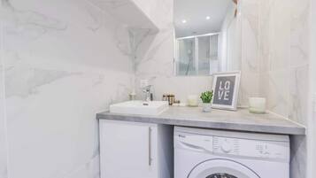 Shower, hair dryer, towels, toilet paper