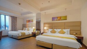 A hotel room with two beds, wooden flooring, and a large window. - BluSalzz Select City Centre near Golden Temple (Amritsar)