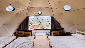 A tented accommodation with two beds, a central table, and large windows. - Bella Dome - Cosy dome with panoramic mountain views, surrounded by beautiful nature (Riols)