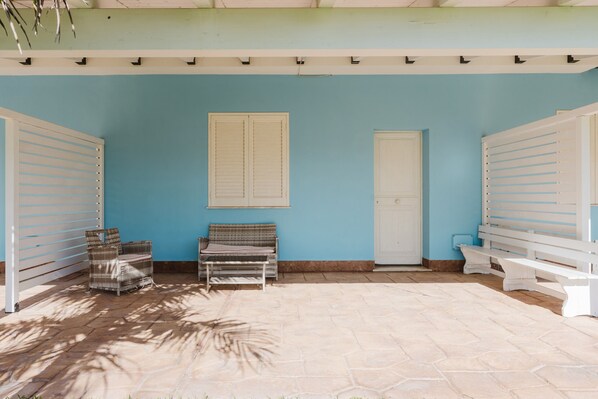 A room with a blue wall, a white door, and a white bench.