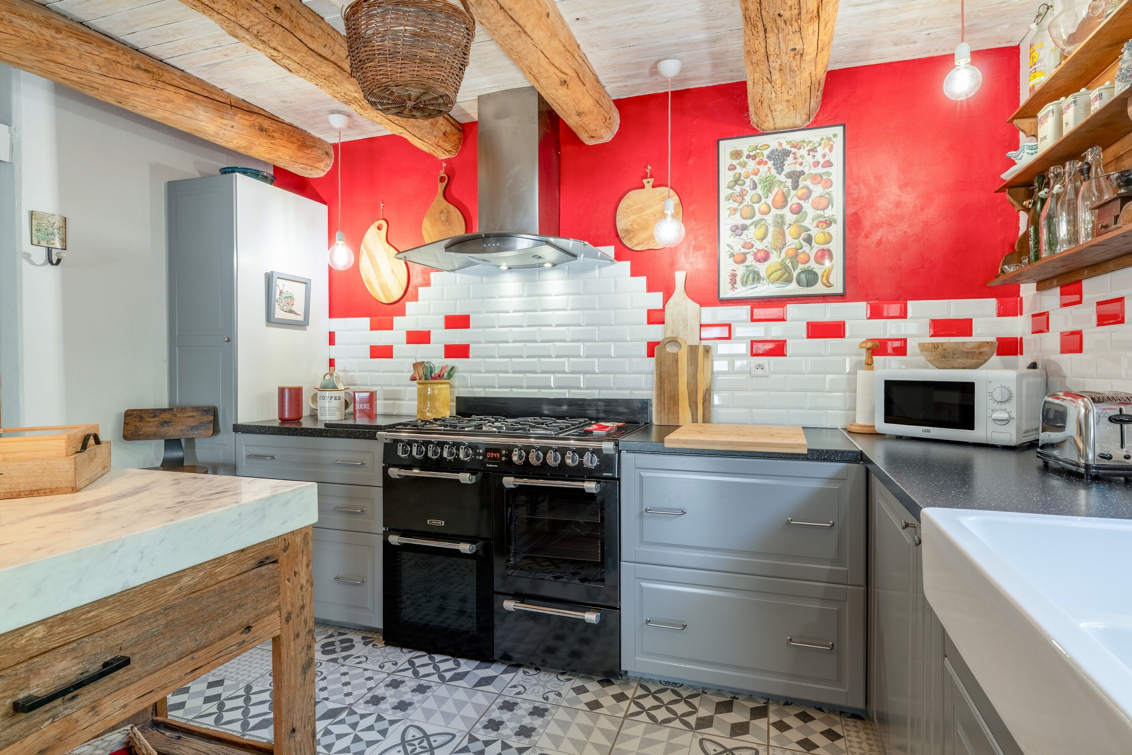 A kitchen with a stove, oven, microwave, and wooden cabinets.