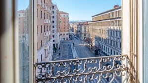 A street view from a balcony with buildings on either side, a clear sky, and a pedestrian crossing. - Enjoy Torino City Center (Torino)