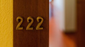 A close-up of a wooden door with the number '222' embossed on it. - San Domenico_222 by Happyhostorino (Torino)