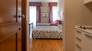 A bedroom with a bed, a nightstand, and a dresser.
